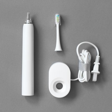Electric toothbrush in packing material
